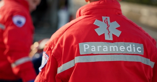 paramedic uniform with Star of Life emblem and Paramedic text visible