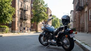 motorcycle parked on urban street with Shoei helmet resting on seat